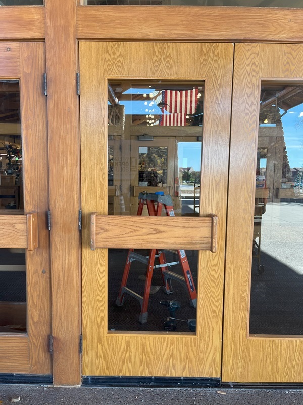 A newly-repaired wood door at the entrance of Cabela's Bass Pro Shops