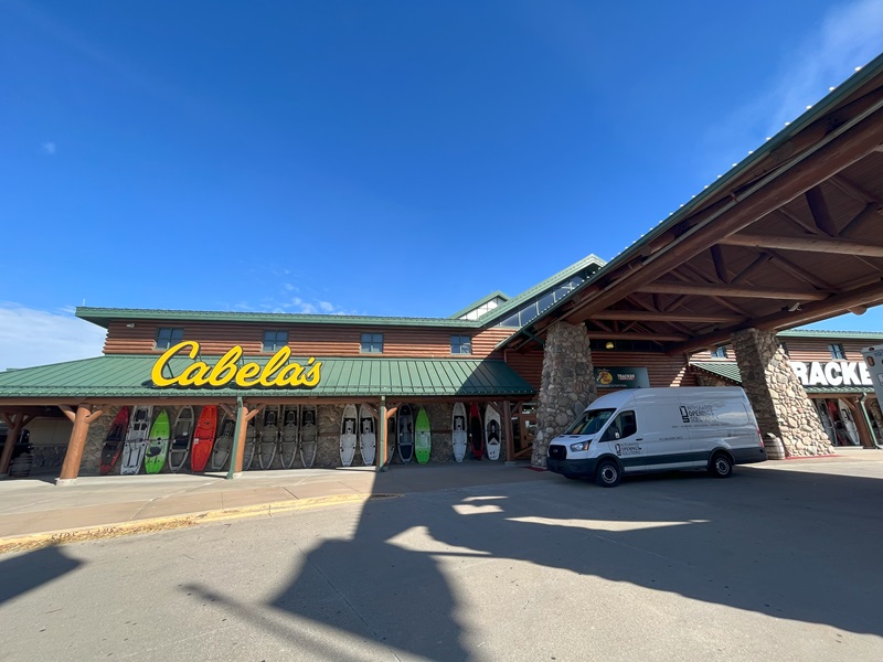 Cabela's drive-up entrance at daytime, with white Integrated Openings Solutions van