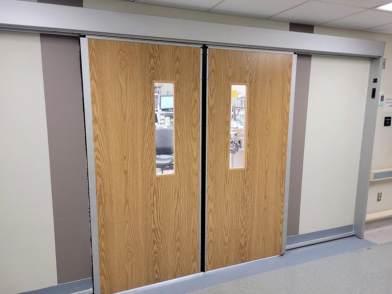 Sliding wood doors for an operating room