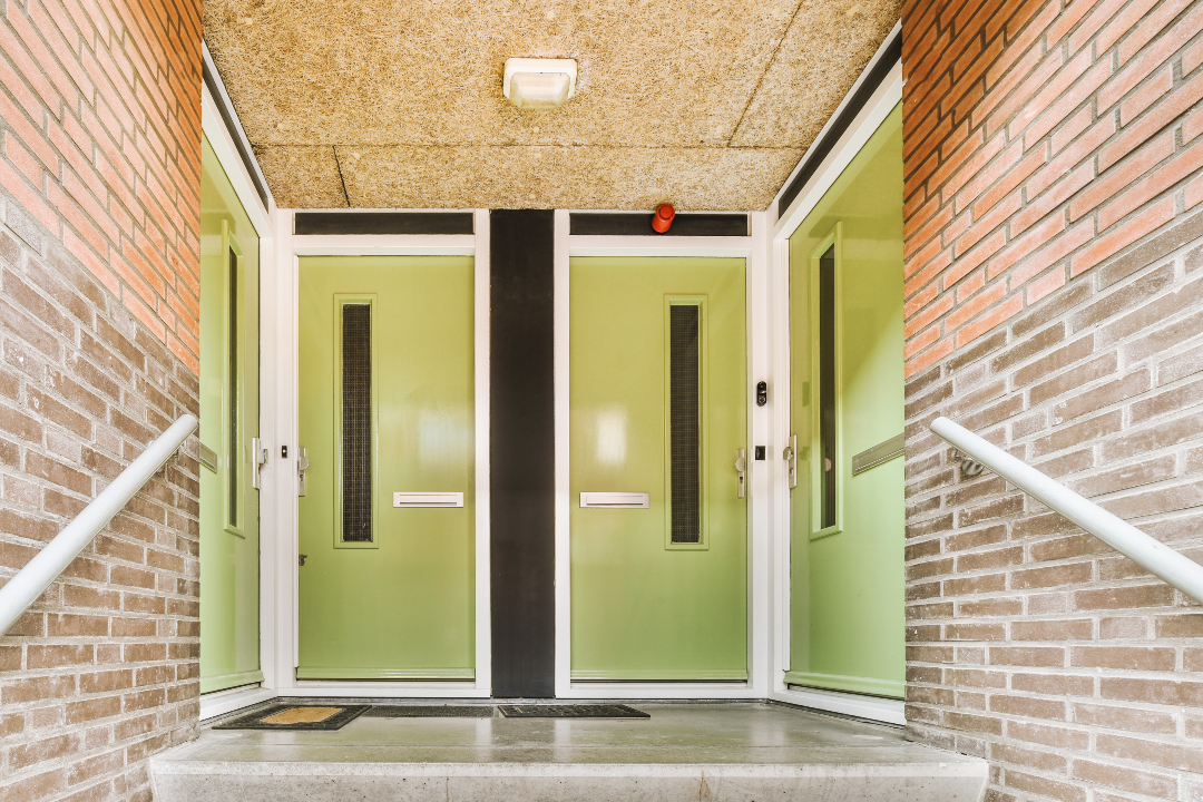 Brick facade and green commercial doors