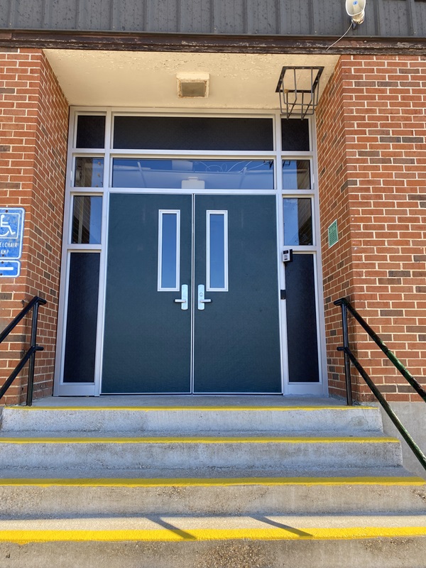 New exterior school doors for Iberia School District, double doors with stairs leading up to entrance.