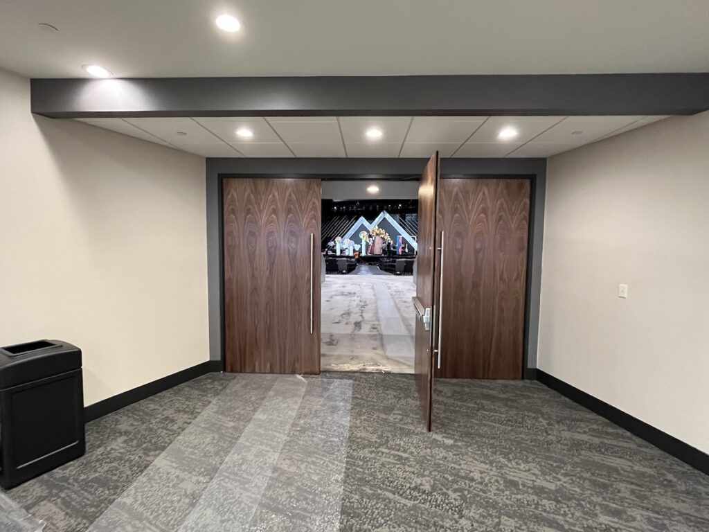 Wood doors at James River Church, opening up to the auditorium