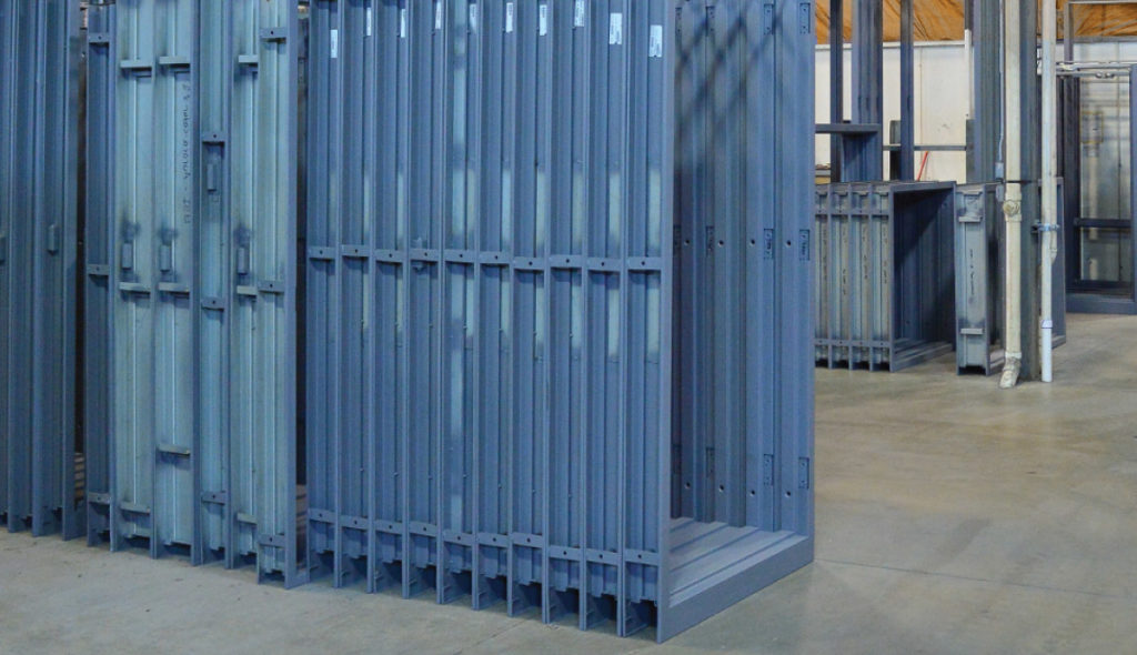 steel doors and frames stacked in warehouse